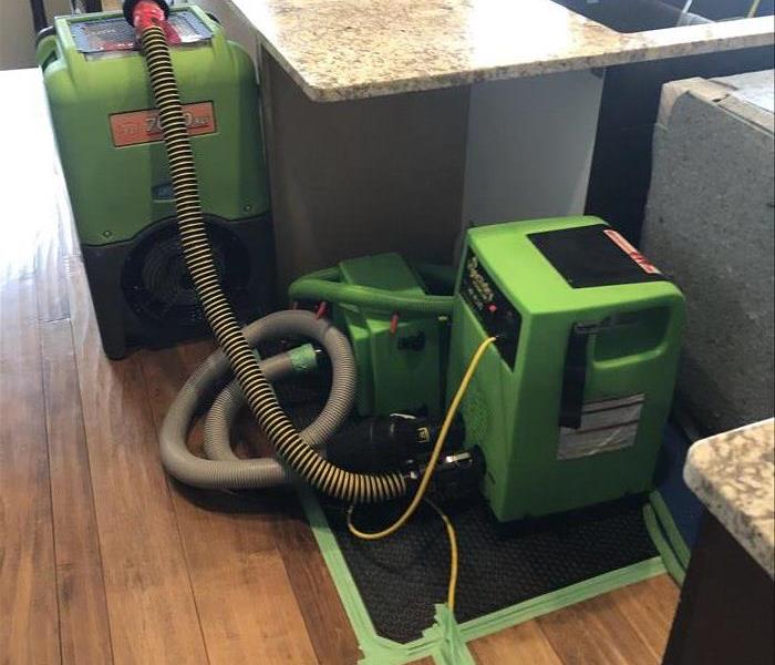 Drying hardwood flooring from a dishwasher leak with our Servpro Dri Eaz floor mat system & dehumidifier in Kelowna, BC.